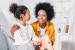 © LIGHTFIELD STUDIOS - african american mother and daughter hugging daughter on rocking horse at home