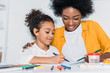 © LIGHTFIELD STUDIOS - african american mother and daughter drawing together at home