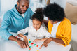 © LIGHTFIELD STUDIOS - african american parents teaching daughter mathematics at home