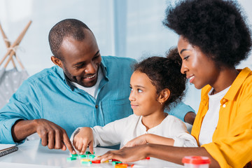 Wall Mural - african american parents teaching daughter mathematics at home