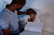 © LIGHTFIELD STUDIOS - african american father holding book and palming sleeping daughter