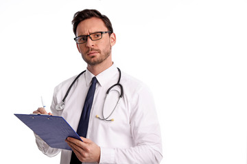 Wall Mural - smart handsome bearded medical doctor in glasses with Stethoscope isolated on white background. Man from hospital with a Clipboard is ready to write something down