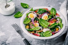 Lunch Bowl Of Spinach Salad With Bacon, Mushrooms, Eggs And Red Onions