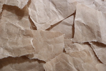 brown ripped crumpled kraft paper scraps garbage beige texture background for design background vintage old paper close-up