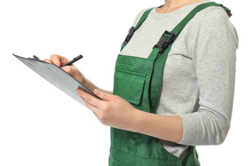 Wall Mural - Female auto mechanic with clipboard and pen on white background, closeup