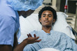 © FS Productions/Blend Images - Black doctor talking to boy in hospital bed
