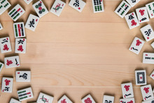White-green Tiles For Mahjong On A Background Of Light Brown Wood. Empty Space In The Center