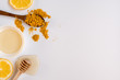 Honey stick, spoon with turmeric and lemon slices top view, copy space
