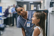 © FS Productions/Blend Images - Nurse measuring height of a girl in the hospital
