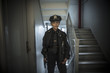 © Steve Prezant/Blend Images - Portrait of older Caucasian policewoman holding gun in apartment staircase