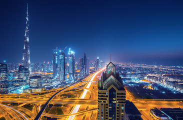 Wall Mural - Dubai skyline after the sunset with beautiful city center lights and Sheikh Zayed road traffic, Dubai, United Arab Emirates