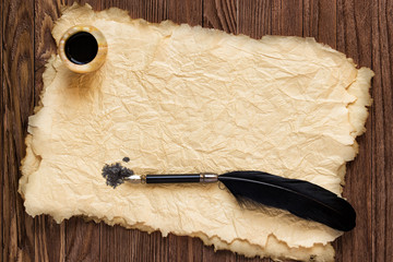 Wall Mural - Pen, old paper and inkwell on a coirish wooden table