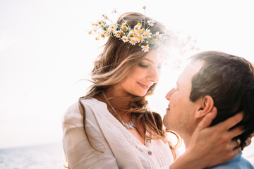 Close-up romantic photo of a loving happy couple who spends time together at sunset near the sea