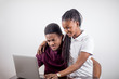 © alfa27 - African couple. black girl sitting in front of laptop lookin at screen and laughing