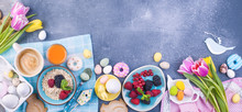 Delicious Spring Breakfast On A Gray Stone Background. A Bouquet Of Fresh Tulips Of Pink And Mint Color. Small And Large Colored Easter Eggs. Oatmeal, Biscuits, Coffee, Fresh Raspberries And Blackberr