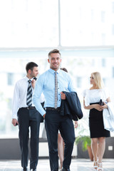 Wall Mural - businessman standing in the center of the modern office