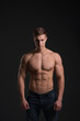 © Anton - man with a sporty physique in the studio on a black background