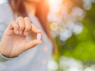 Close up of woman hand holding pills. Health care and medical concept.