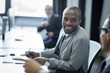 © LIGHTFIELD STUDIOS - selective focus of multicultural businessmen having conversation at workplace in office