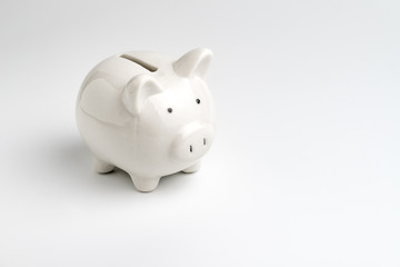 Finance, saving money, white piggy bank on seamless white background