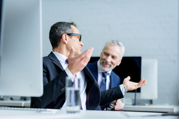 Wall Mural - business colleagues having conversation during work in office