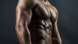 Torso of handsome, strong and sexy male fitness model/bodybuilder poses on dark background