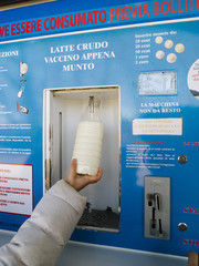 children take raw milk from a distributor