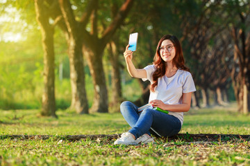 Wall Mural - woman using mobile phone in park