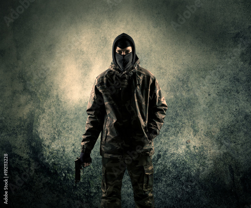 Cuadros en Lienzo Portrait of a heavily armed masked soldier with grungy background