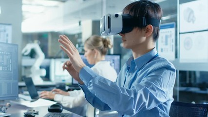 Wall Mural - computer science engineer wearing virtual reality headset works with 3d modeling, makes gestures. in