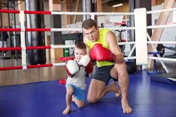 Wall Mural - Little boy with trainer in boxing ring