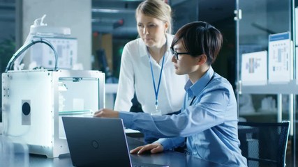 Wall Mural - two engineers work with three dimensional printer in laboratory