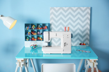 Wall Mural - Sewing machine with fabric on table in tailor workshop