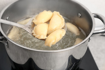 Wall Mural - Cooking dumplings in boiling water, closeup