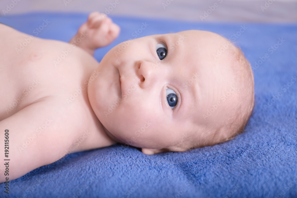 Cute little baby lying on bed, closeup