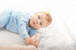 © Africa Studio - Cute little baby with toy lying on bed