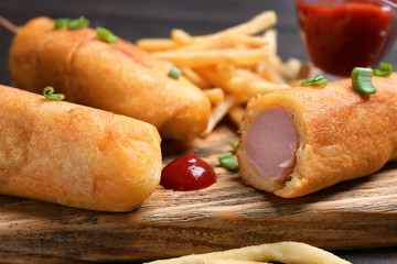 Wall Mural - Tasty corn dogs with ketchup, closeup