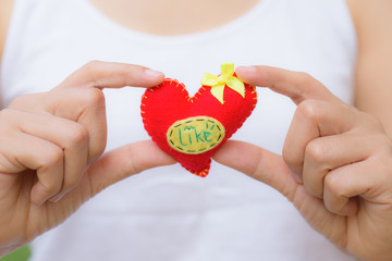 Wall Mural - Woman holding a red heart shaped for Valentines day and  love concept.