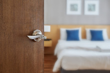 Hotel Room Interior, Condominium Or Apartment Doorway With Opened Door In Front Of Blur Bedroom Background