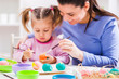 © djoronimo - Happy mother and daughter coloring eggs for Easter.