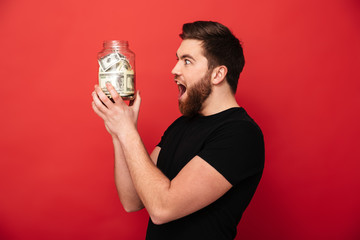 Sticker - Excited bearded man holding jar full of money.