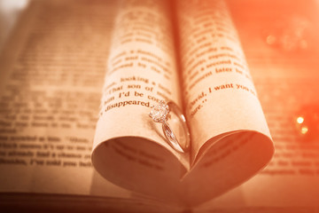 two wedding rings on a bible