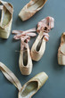 Group of old used pointe shoes. Worn female ballet shoes, top view. Concept of classical ballet.