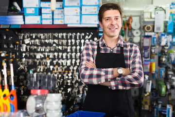 Wall Mural - worker in hardware store trading goods for water tap in uniform