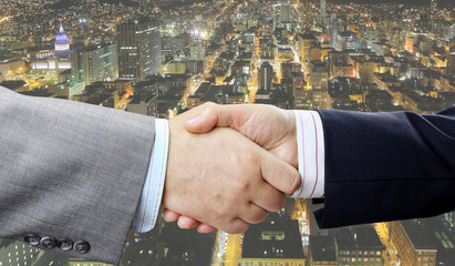 Aufkleber - Closeup of business people handshake on big city at night background 