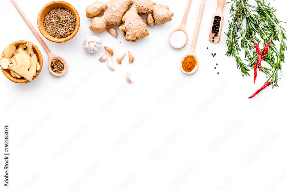 Seasoning background. Dry spices near ginger, garlic, rosemary, chili on white background top view copy space - obrazy, fototapety, plakaty 