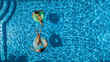 © Iuliia Sokolovska - Aerial top view of children in swimming pool from above, happy kids swim on inflatable ring donuts and have fun in water on family holiday vacation on resort