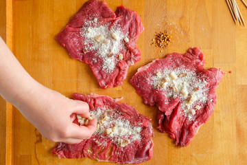 Making stuffed meat roll called braciola typical of Apulia region, Italy