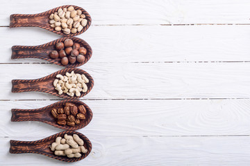 Wall Mural - Mix of nuts in wooden spoon