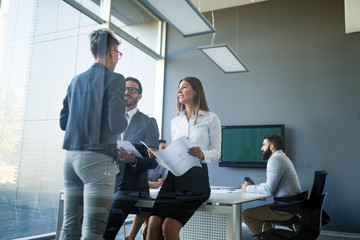 Picture of business colleagues talking in office